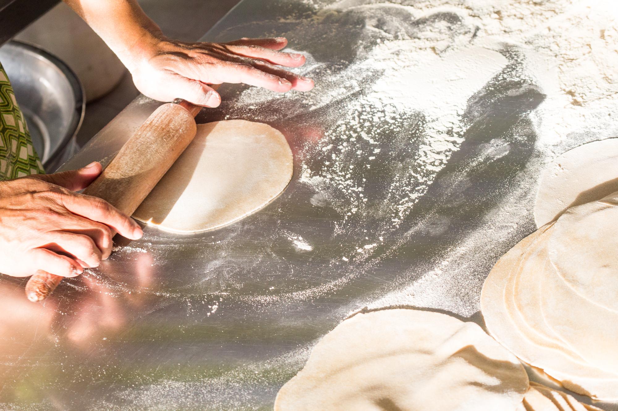 Hands kneading dough in studio kitchen
